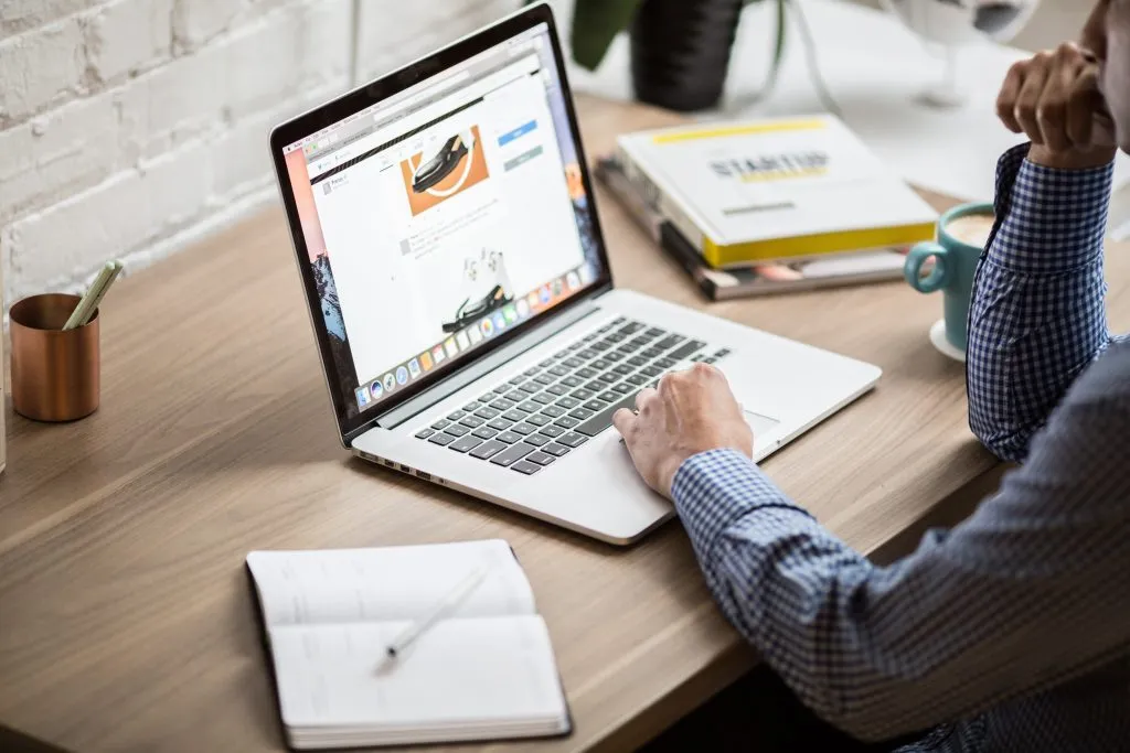 Person uses laptop with product page open from website